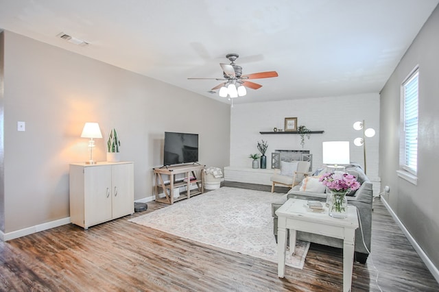 3405 44th St, Snyder, TX 79549 - living area featuring a ceiling fan, wood finished floors, baseboards, and visible vents