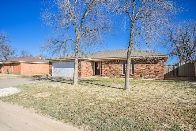 3405 44th St, Snyder, TX 79549 - ranch-style house featuring fence, a garage, brick siding, and concrete driveway