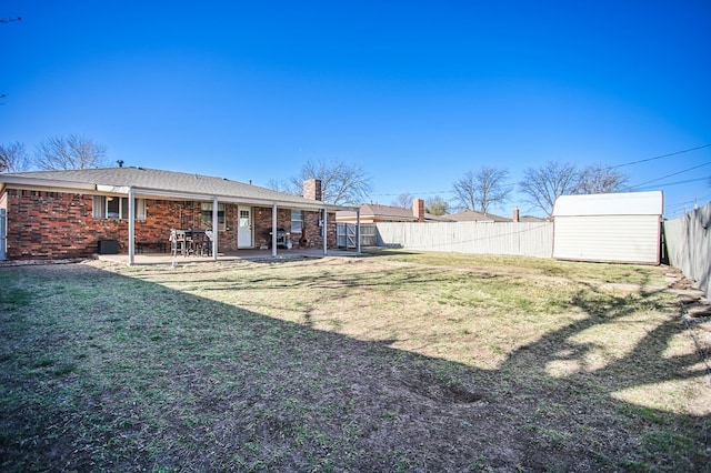 3405 44th St, Snyder, TX 79549 - view of yard with an outbuilding, a patio area, a fenced backyard, and a shed