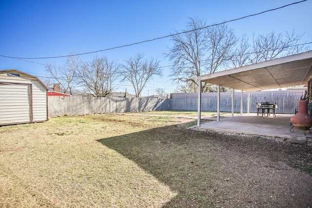 3405 44th St, Snyder, TX 79549 - view of yard with a storage unit, an outdoor structure, a fenced backyard, and a patio area