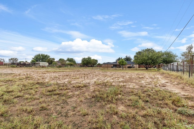 view of yard with a rural view and fence