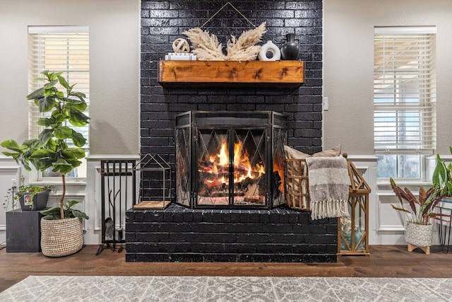 details featuring a fireplace and wood finished floors