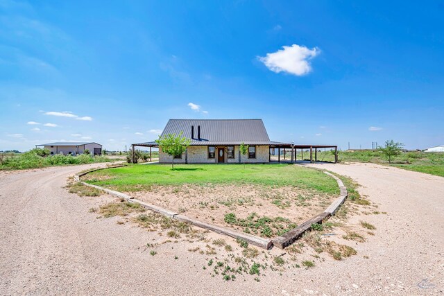 10500 E County Rd 90, Midland, TX 79706 - farmhouse inspired home featuring driveway, metal roof, and a carport