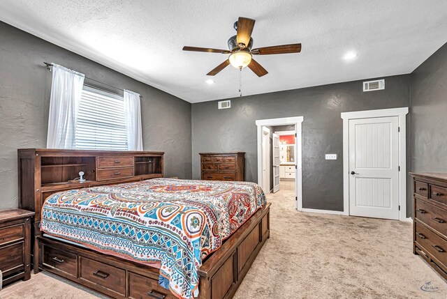 10500 E County Rd 90, Midland, TX 79706 - bedroom featuring a textured wall, a textured ceiling, light carpet, ensuite bathroom, and a ceiling fan