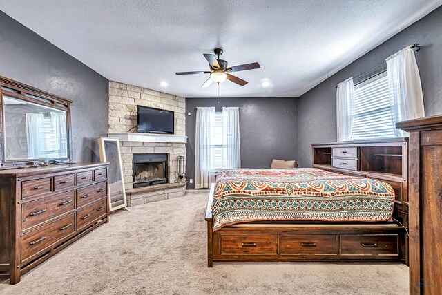 10500 E County Rd 90, Midland, TX 79706 - carpeted bedroom featuring a textured ceiling, a fireplace, and ceiling fan