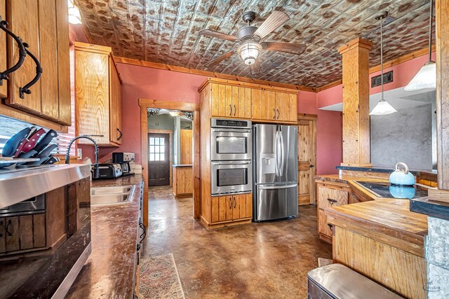 10500 E County Rd 90, Midland, TX 79706 - kitchen featuring stainless steel appliances, finished concrete floors, ceiling fan, pendant lighting, and an ornate ceiling