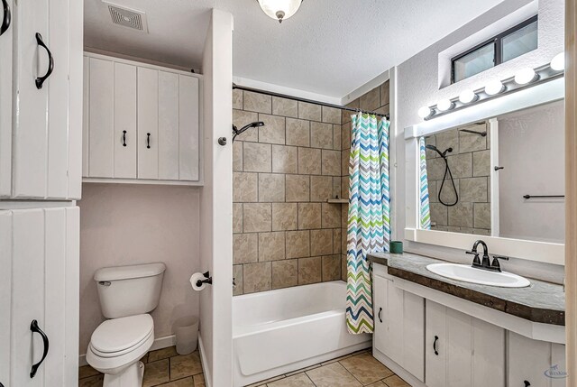 10500 E County Rd 90, Midland, TX 79706 - bathroom featuring toilet, vanity, shower / bath combo with shower curtain, tile patterned flooring, and a textured ceiling