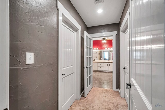 10500 E County Rd 90, Midland, TX 79706 - hallway with light colored carpet and french doors