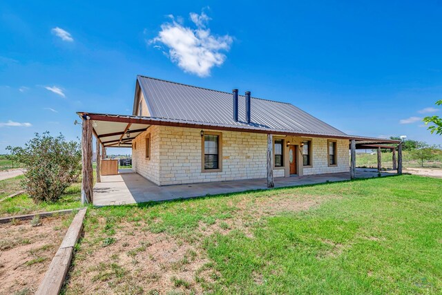 10500 E County Rd 90, Midland, TX 79706 - rear view of property with a yard, a carport, and metal roof