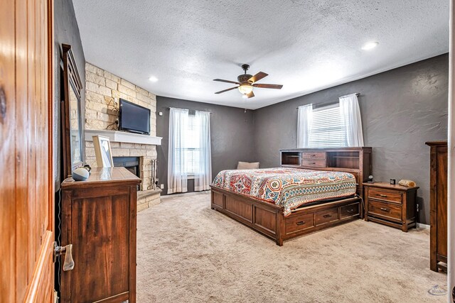 10500 E County Rd 90, Midland, TX 79706 - bedroom featuring a textured ceiling, carpet floors, and a stone fireplace