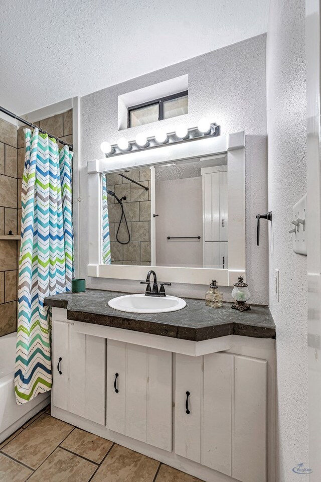 10500 E County Rd 90, Midland, TX 79706 - bathroom featuring a textured wall, vanity, shower / bath combination with curtain, tile patterned floors, and a textured ceiling