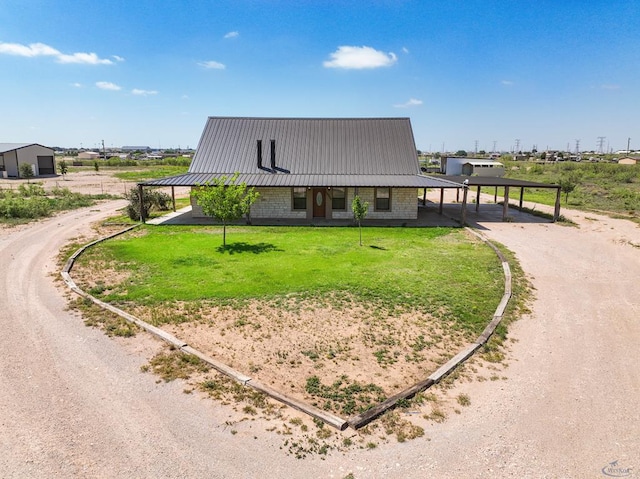 10500 E County Rd 90, Midland, TX 79706 - view of front of home featuring dirt driveway, a front yard, and metal roof