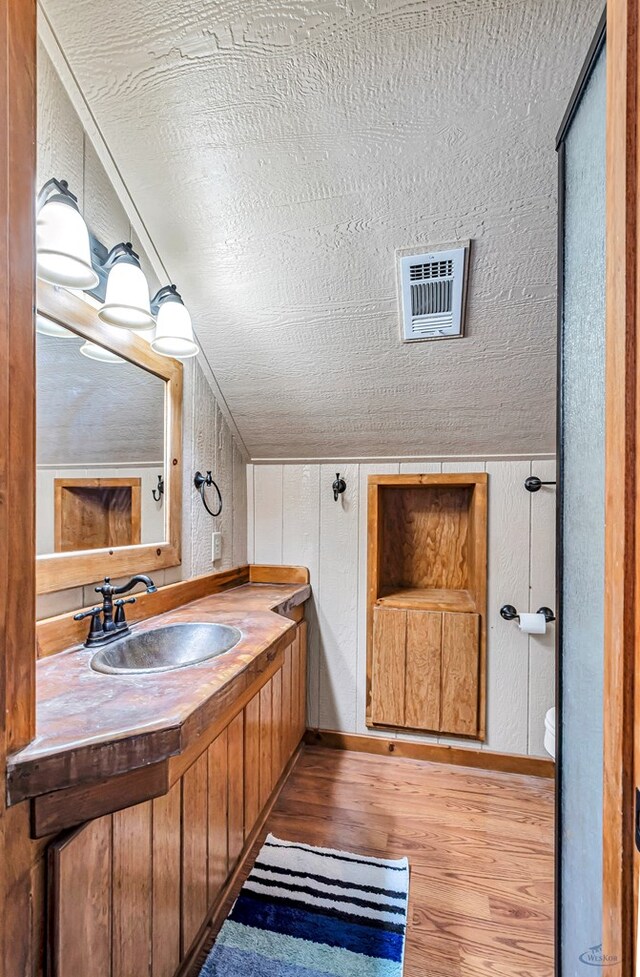 10500 E County Rd 90, Midland, TX 79706 - bathroom featuring wood finished floors, vanity, and baseboards