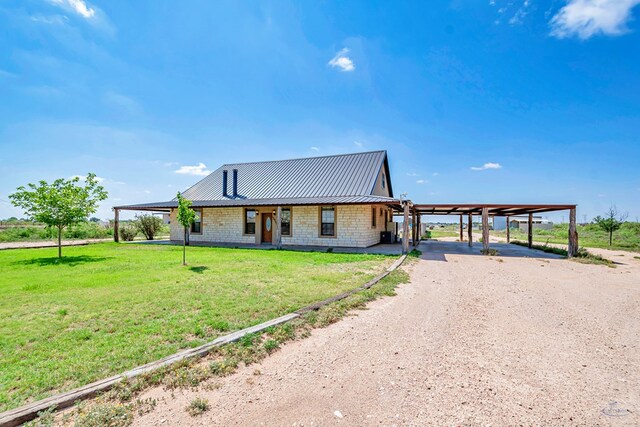 10500 E County Rd 90, Midland, TX 79706 - farmhouse inspired home with a front lawn, an attached carport, metal roof, and dirt driveway