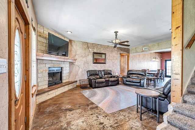 10500 E County Rd 90, Midland, TX 79706 - living room with a ceiling fan, a fireplace, and unfinished concrete flooring