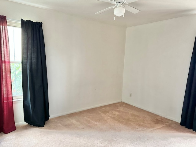 carpeted spare room with ceiling fan