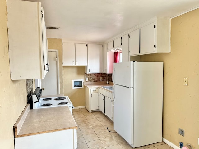 kitchen featuring white cabinetry, light tile patterned flooring, white appliances, and sink