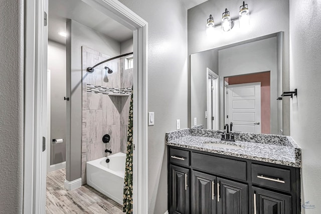 6003 Sunny Stone Dr, Midland, TX 79705 - full bath with vanity, wood finished floors, and shower / tub combination