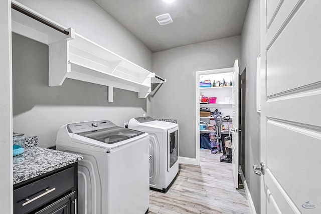 6003 Sunny Stone Dr, Midland, TX 79705 - laundry room featuring independent washer and dryer, light wood-type flooring, and cabinet space