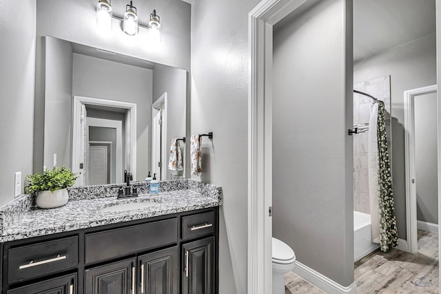 6003 Sunny Stone Dr, Midland, TX 79705 - bathroom with wood finished floors, vanity, and shower / bath combo with shower curtain