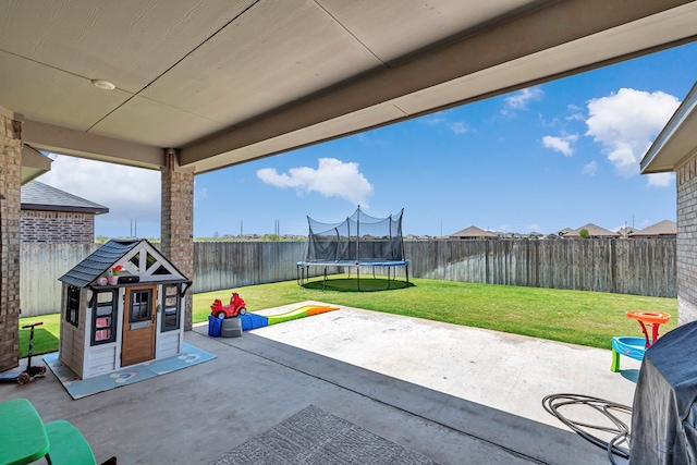 6003 Sunny Stone Dr, Midland, TX 79705 - fenced backyard with a trampoline and a patio