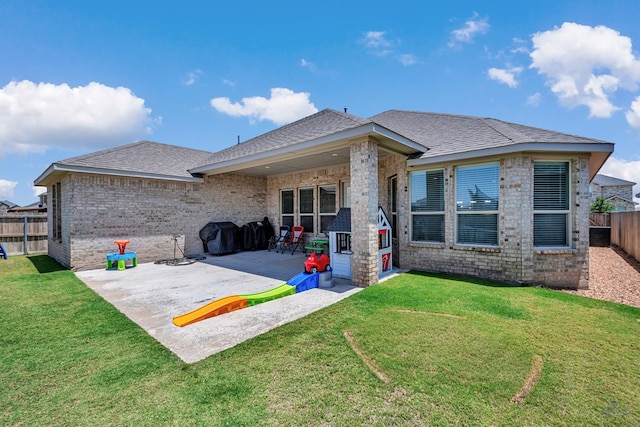 6003 Sunny Stone Dr, Midland, TX 79705 - back of property featuring a patio area, a fenced backyard, roof with shingles, and brick siding
