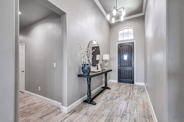 6003 Sunny Stone Dr, Midland, TX 79705 - foyer featuring wood finished floors, ornamental molding, and a chandelier