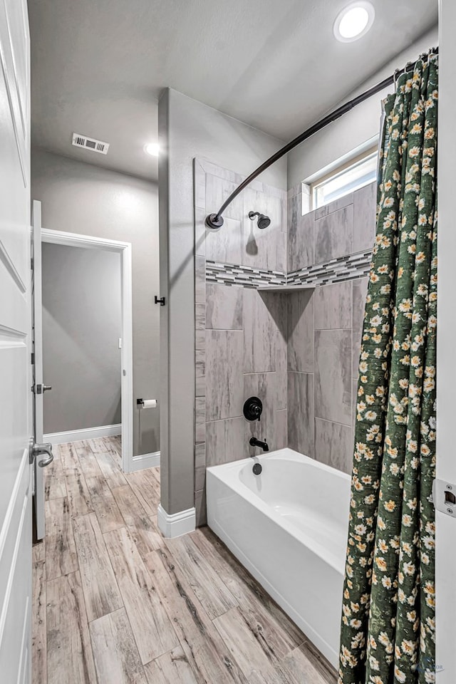 6003 Sunny Stone Dr, Midland, TX 79705 - bathroom featuring shower / bathtub combination with curtain and wood finished floors