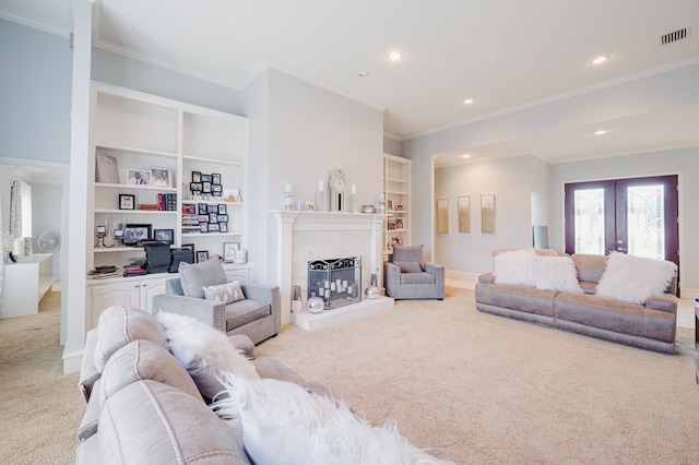 5000 Thames Ct, Midland, TX 79705 - carpeted living area featuring ornamental molding, french doors, recessed lighting, built in shelves, and a fireplace