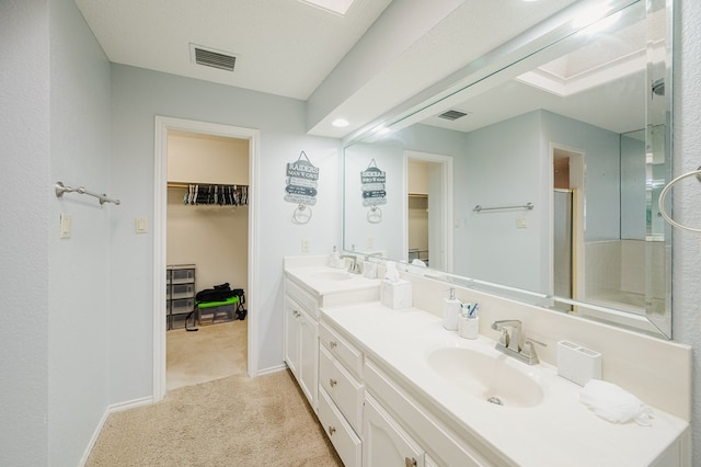 5000 Thames Ct, Midland, TX 79705 - full bath featuring double vanity, a spacious closet, a shower stall, and baseboards