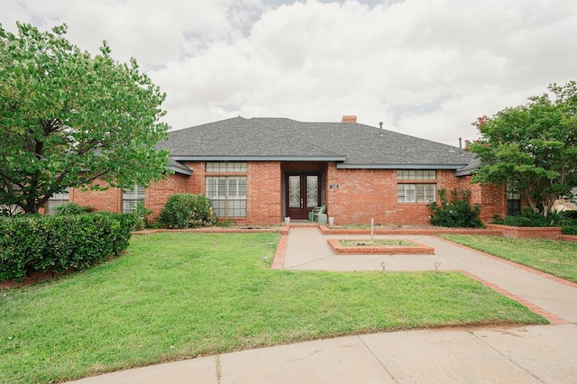 5000 Thames Ct, Midland, TX 79705 - ranch-style house featuring french doors, brick siding, a front yard, and a shingled roof