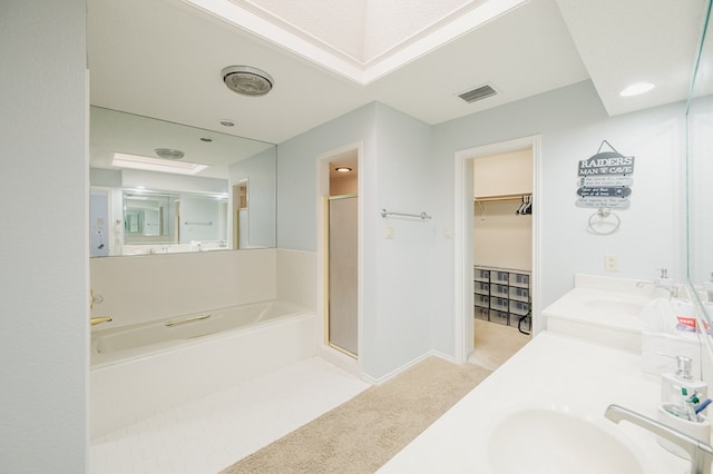 5000 Thames Ct, Midland, TX 79705 - bathroom featuring a stall shower, a bath, double vanity, a spacious closet, and baseboards