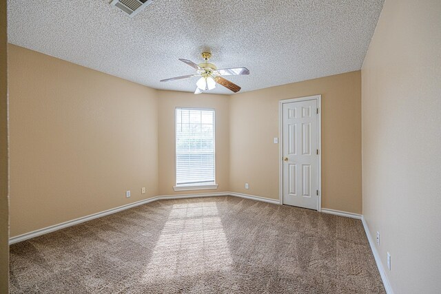 4513 Rosewood Dr, Midland, TX 79707 - spare room with a ceiling fan, a textured ceiling, visible vents, carpet floors, and baseboards