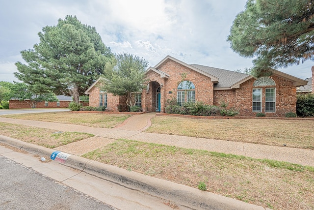 4513 Rosewood Dr, Midland, TX 79707 - ranch-style home with brick siding and a front yard