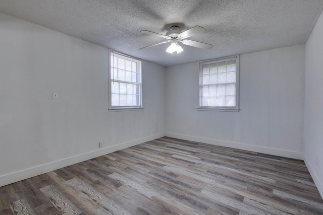 107 W 10th St, Big Spring, TX 79720 - empty room featuring ceiling fan, wood finished floors, and a textured ceiling