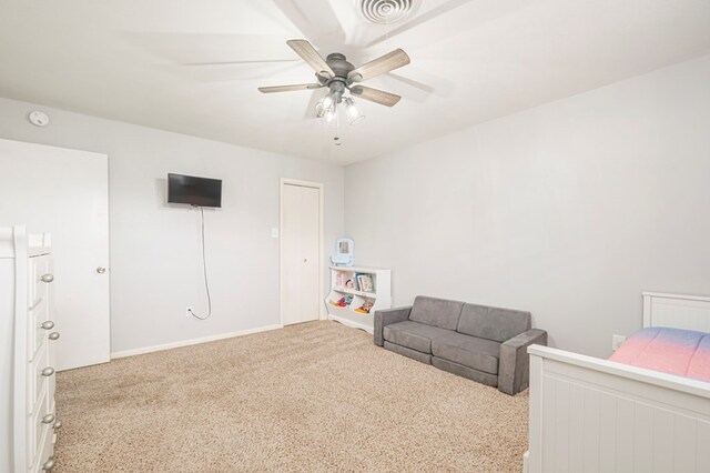 bedroom featuring ceiling fan and light carpet