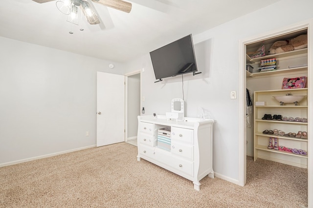 bedroom featuring ceiling fan and light carpet