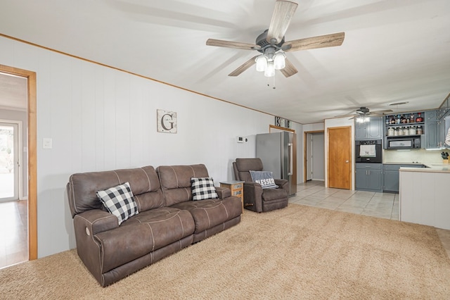 living room featuring light carpet and ceiling fan