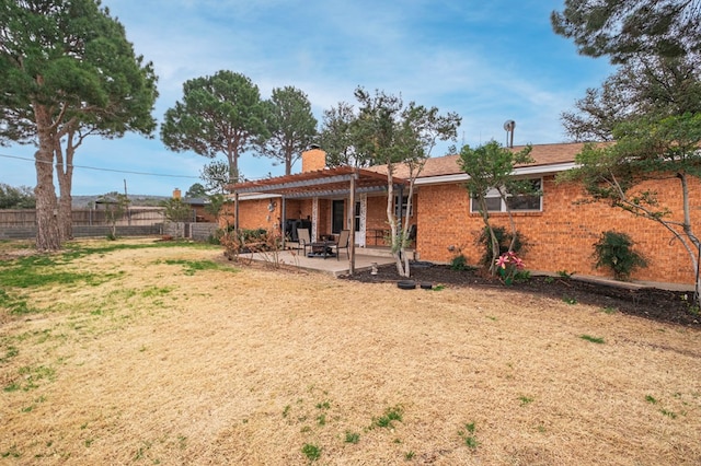 back of property featuring a patio area and a pergola