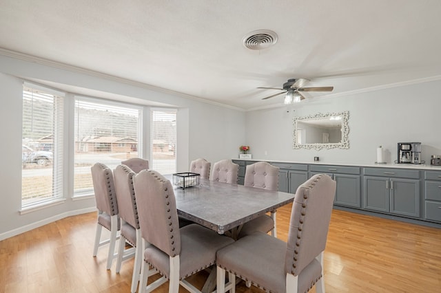 dining room featuring ceiling fan, light hardwood / wood-style flooring, and crown molding