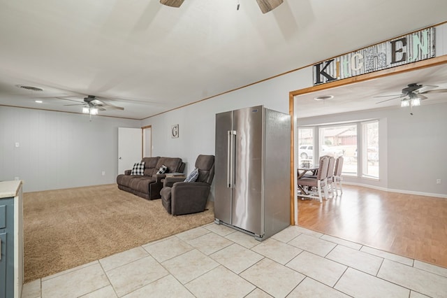 living room featuring light carpet and ceiling fan