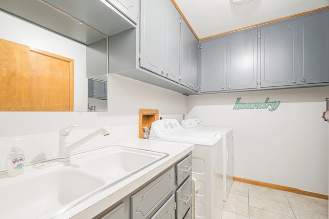 laundry area with washer and dryer, cabinets, sink, and light tile patterned flooring