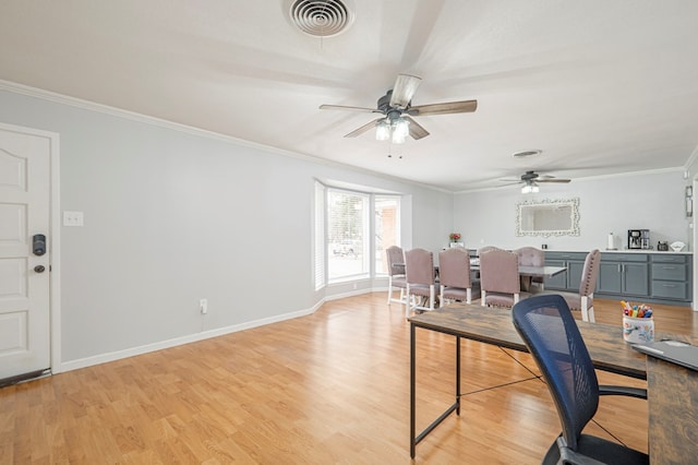 office space featuring light hardwood / wood-style floors, crown molding, and ceiling fan