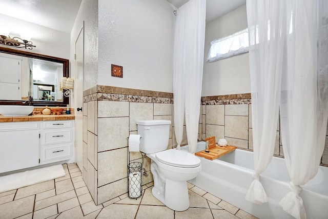 2406 Stutz Pl, Midland, TX 79705 - bathroom featuring shower / bath combination with curtain, vanity, a textured wall, tile walls, and wainscoting