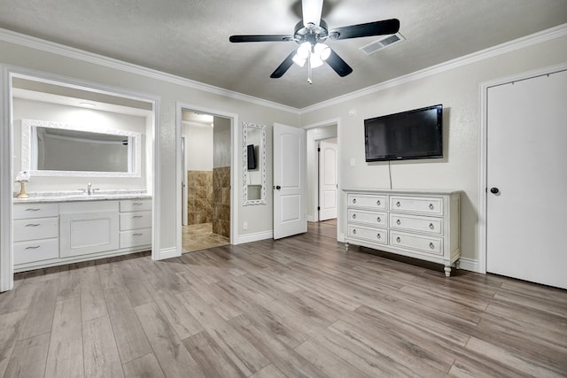2406 Stutz Pl, Midland, TX 79705 - unfurnished bedroom featuring light wood finished floors, crown molding, a textured ceiling, connected bathroom, and ceiling fan