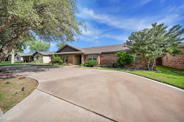 2406 Stutz Pl, Midland, TX 79705 - single story home with brick siding, curved driveway, and a front lawn