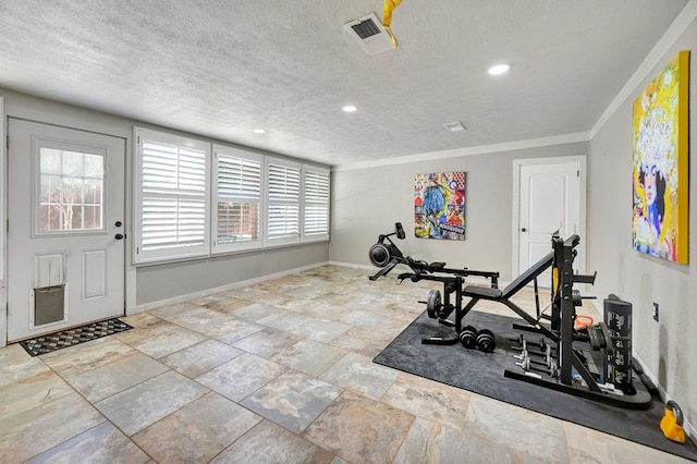 2406 Stutz Pl, Midland, TX 79705 - exercise room featuring healthy amount of natural light, ornamental molding, a textured ceiling, recessed lighting, and stone finish floors