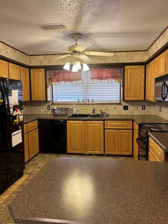 297 County Rd 221, Snyder, TX 79549 - kitchen with dark countertops, a sink, black appliances, a textured ceiling, and ceiling fan