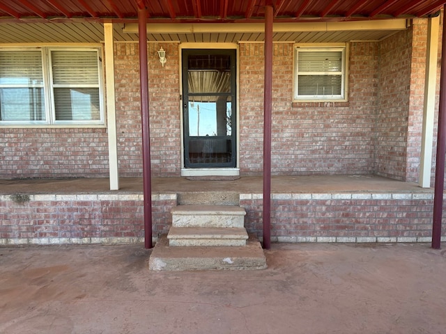 297 County Rd 221, Snyder, TX 79549 - doorway to property featuring a porch and brick siding