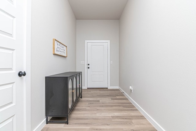 entryway with light wood finished floors and baseboards